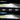 Action shot of the EZ-GO TXT 2014+ Golf Cart LED High Low Beam Light Kit with brake pads 12-48 volt in use, lighting up a golf course at night.